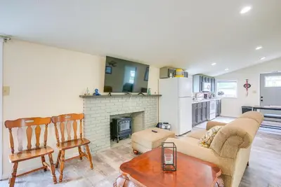 a living room with a couch and a fireplace at Grand Lake Cabin with Private Dock in St Marys!