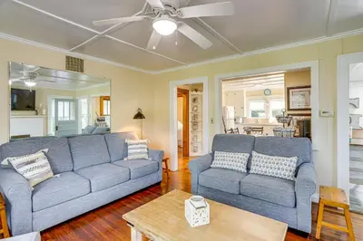 a living room with two couches and a ceiling fan at Walk to Private Beach Lake Erie Retreat with Yard! in Huron
