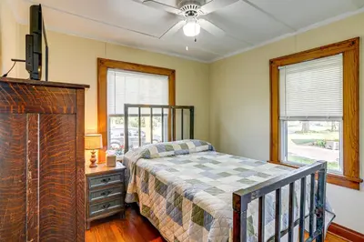 a bedroom with a bed and a dresser and a tv at Walk to Private Beach Lake Erie Retreat with Yard! in Huron