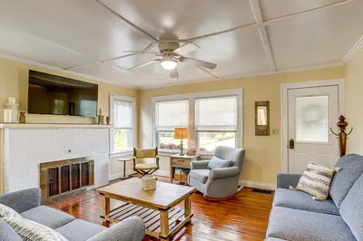 a living room with two couches and a fireplace at Walk to Private Beach Lake Erie Retreat with Yard! in Huron