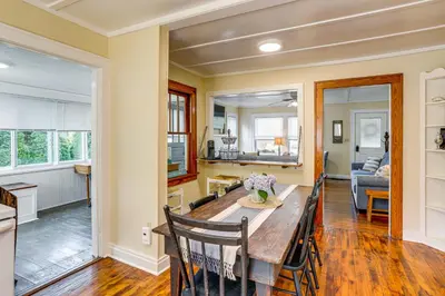a dining room and kitchen with a table and chairs at Walk to Private Beach Lake Erie Retreat with Yard! in Huron