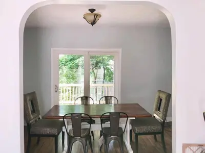 a dining room with a wooden table and chairs at The House Hotels - W45th Backhouse - Ohio City in Cleveland
