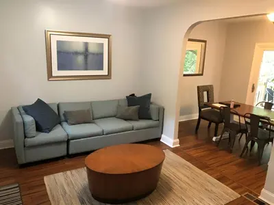 a living room with a couch and a table at The House Hotels - W45th Backhouse - Ohio City in Cleveland