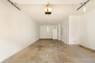 an empty room with white walls and a concrete floor at The Penny Lane Suite in Akron