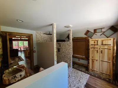 a living room with wood floors and a room with a ceiling at A Birds Eye View Cabin Rentals in Logan