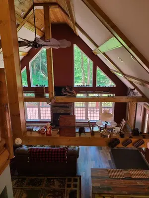 an attic view of a living room with windows at A Birds Eye View Cabin Rentals in Logan