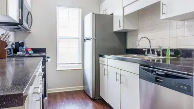 a kitchen with white cabinets and a stainless steel refrigerator at Landing Chic 1BD Clubhouse Gym in Dayton