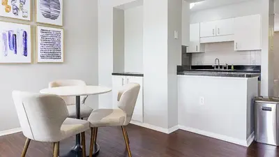 a white kitchen with a table and chairs at Landing Chic 1BD Clubhouse Gym in Dayton