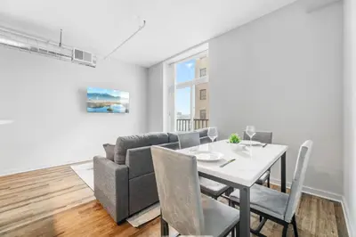 a dining room and living room with a table and a couch at Spacious DT Condo l Free Parking l Fast Wi-Fi in Cleveland