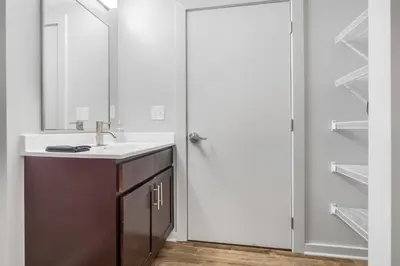 a bathroom with a sink and a mirror at Spacious DT Condo l Free Parking l Fast Wi-Fi in Cleveland