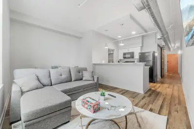 a living room with a couch and a table at Spacious DT Condo l Free Parking l Fast Wi-Fi in Cleveland