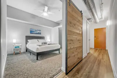 a bedroom with a bed and a wooden wall at Spacious DT Condo l Free Parking l Fast Wi-Fi in Cleveland