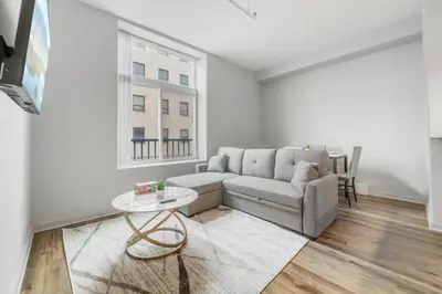 a living room with a couch and a table at Spacious DT Condo l Free Parking l Fast Wi-Fi in Cleveland