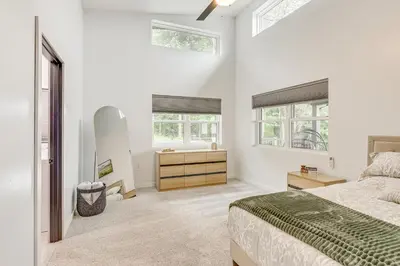 a bedroom with a bed and a dresser and windows at 4 Mi to Mohican River Ohio Amish Country Cottage in Walhonding