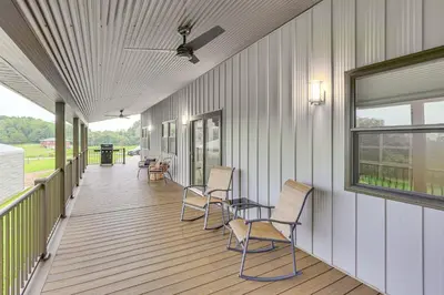 a covered porch with chairs and a table on it at 4 Mi to Mohican River Ohio Amish Country Cottage in Walhonding