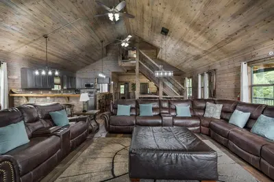 a living room with leather furniture and a wooden ceiling at Serenity Ridge 6 Br Sleeps 16 Pool Hot Tub in Creola