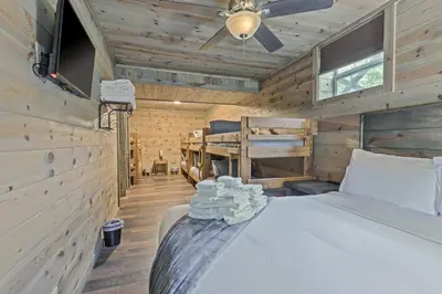 a bedroom with a bed and a ceiling fan at Serenity Ridge 6 Br Sleeps 16 Pool Hot Tub in Creola
