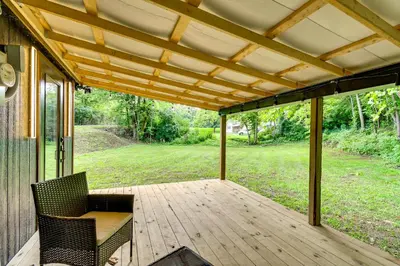 a porch with two chairs and a wooden deck at BBQ Ready Retreat on Rice Near Licking River