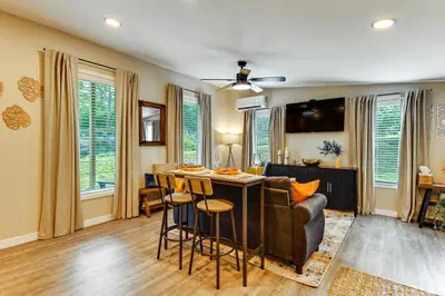 a living room with a bar with a couch and a table at BBQ Ready Retreat on Rice Near Licking River