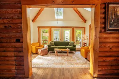 a living room with a green couch and yellow chairs at Diamond Creek | Sleeps up to 6 in Gallipolis
