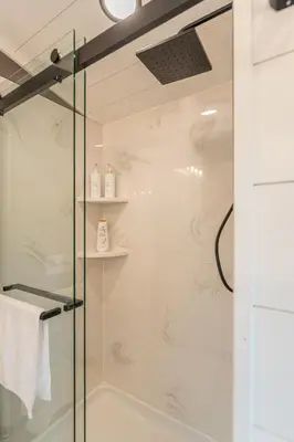 a bathroom with a shower with a glass door at Luxe Studio in Millersburg