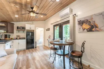 a kitchen and living room with a table and chairs at Luxe Studio in Millersburg