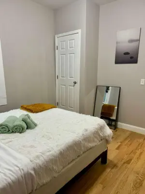 a bedroom with a white bed and a mirror at Jungle House Columbus Downtown Free Parking Sleeps 8 - Near Convention Center & Nationwide Arena - 2BR Short North Luxury Home - Over 5,800 Five Star Stays in Columbus
