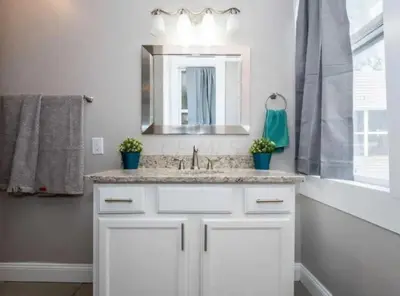 a white bathroom with a sink and a mirror at Jungle House Columbus Downtown Free Parking Sleeps 8 - Near Convention Center & Nationwide Arena - 2BR Short North Luxury Home - Over 5,800 Five Star Stays in Columbus