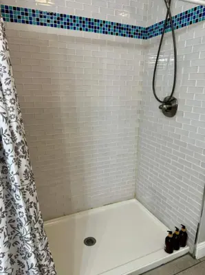 a bathroom with a shower curtain and a tub at Jungle House Columbus Downtown Free Parking Sleeps 8 - Near Convention Center & Nationwide Arena - 2BR Short North Luxury Home - Over 5,800 Five Star Stays in Columbus