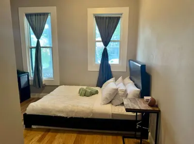 a bedroom with a bed and two windows at Jungle House Columbus Downtown Free Parking Sleeps 8 - Near Convention Center & Nationwide Arena - 2BR Short North Luxury Home - Over 5,800 Five Star Stays in Columbus
