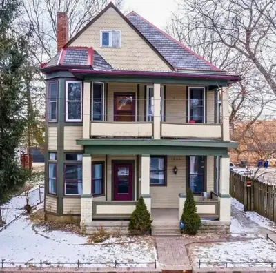 an old house with snow on the ground at Jungle House Columbus Downtown Free Parking Sleeps 8 - Near Convention Center & Nationwide Arena - 2BR Short North Luxury Home - Over 5,800 Five Star Stays in Columbus