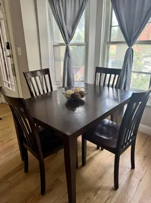 a wooden table with chairs and a bowl of fruit on it at Jungle House Columbus Downtown Free Parking Sleeps 8 - Near Convention Center & Nationwide Arena - 2BR Short North Luxury Home - Over 5,800 Five Star Stays in Columbus