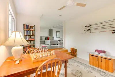 a living room with a wooden table with chessetts on it at 1 Mi to Burr Oak Lake Cozy Family Home! in Corning