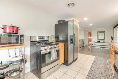 a kitchen with a stainless steel stove and refrigerator at 1 Mi to Burr Oak Lake Cozy Family Home! in Corning