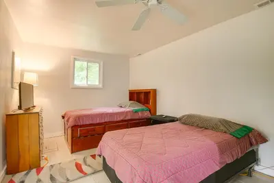 a bedroom with two beds and a tv at 1 Mi to Burr Oak Lake Cozy Family Home! in Corning