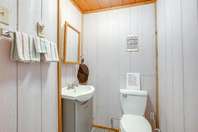 a small bathroom with a toilet and a sink at 1 Mi to Burr Oak Lake Cozy Family Home! in Corning