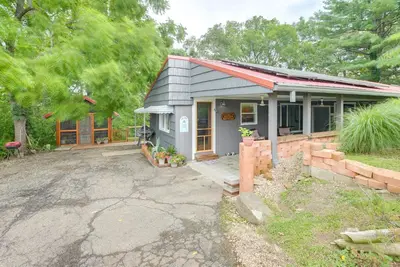 a small house with a driveway in front of it at 1 Mi to Burr Oak Lake Cozy Family Home! in Corning
