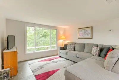 a living room with a couch and a tv at 1 Mi to Burr Oak Lake Cozy Family Home! in Corning