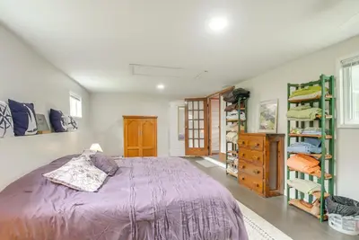 a bedroom with a purple bed and a book shelf at 1 Mi to Burr Oak Lake Cozy Family Home! in Corning