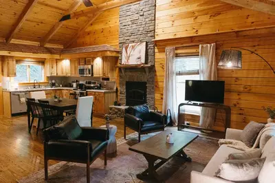 a living room with a couch and a table in a cabin at 