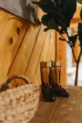 a wooden table with a glass and a basket on it at 
