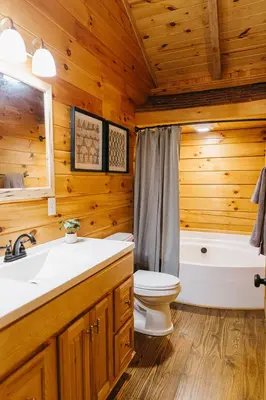 a bathroom with a toilet and a sink and a tub at 