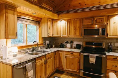 a kitchen with wooden cabinets and a sink and a stove at 