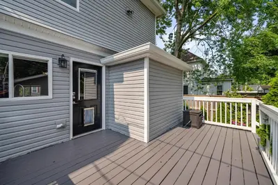 a house with a wooden deck next to a house at The Southern Nook - For 8 in Columbus