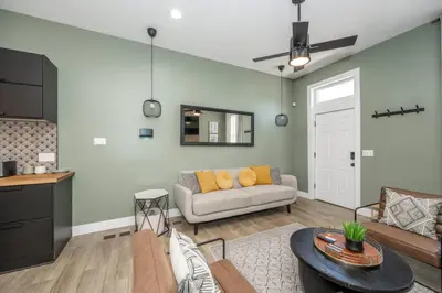 a living room with a couch and a table at The Baymiller Row - For 6 in Cincinnati