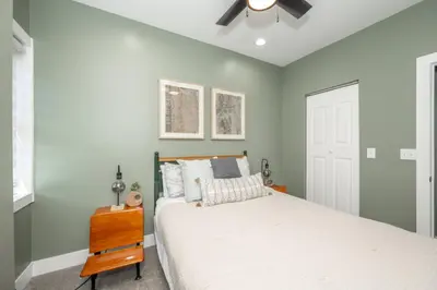 a bedroom with a bed and a ceiling fan at The Baymiller Row - For 6 in Cincinnati