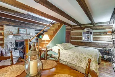 a bedroom with a bed in a room with wooden walls at 3 Mi to River 11-Acre Retreat in Rural Stockport in Chesterhill