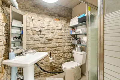 a bathroom with a white toilet and a sink at 3 Mi to River 11-Acre Retreat in Rural Stockport in Chesterhill