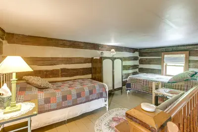 a bedroom with two beds and a table with a lamp at 3 Mi to River 11-Acre Retreat in Rural Stockport in Chesterhill