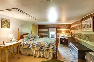a bedroom with a bed and a desk and a kitchen at 3 Mi to River 11-Acre Retreat in Rural Stockport in Chesterhill